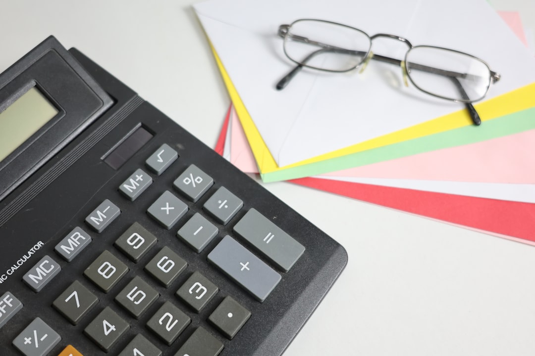 calculator-and-glasses-on-colorful-papers-jacfrvlnmfq